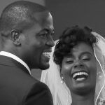 groom and bride together laughing and smiling at reception
